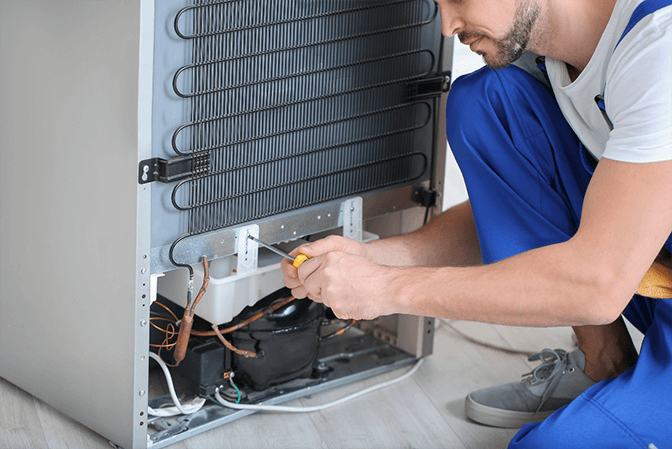 Refrigerator door hinge alignment service in Abu Dhabi - Abu Dhabi Appliance Repair technician adjusting misaligned doors